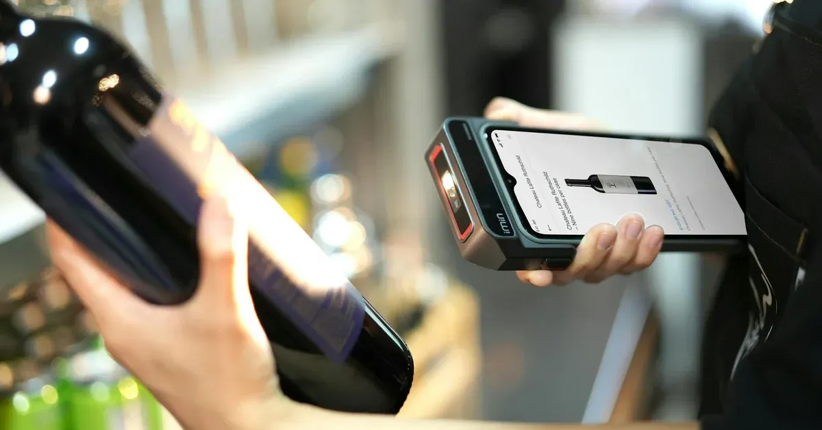 Black and white photo of two individuals walking across a rustic wooden bridge or pathway, suggesting a border crossing or journey in a developing region of Southeast Asia, hinting at travel and potential cultural encounters.